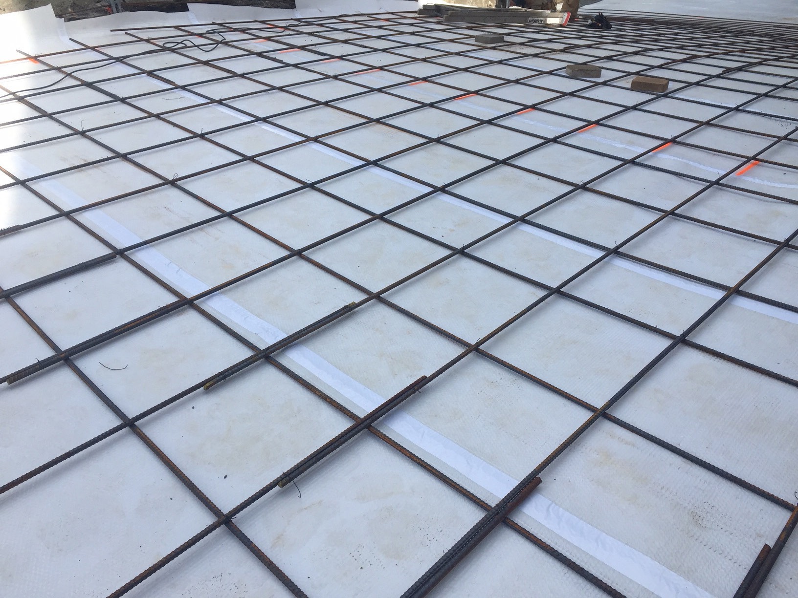 Radiant heating grid prepared beneath a concrete slab